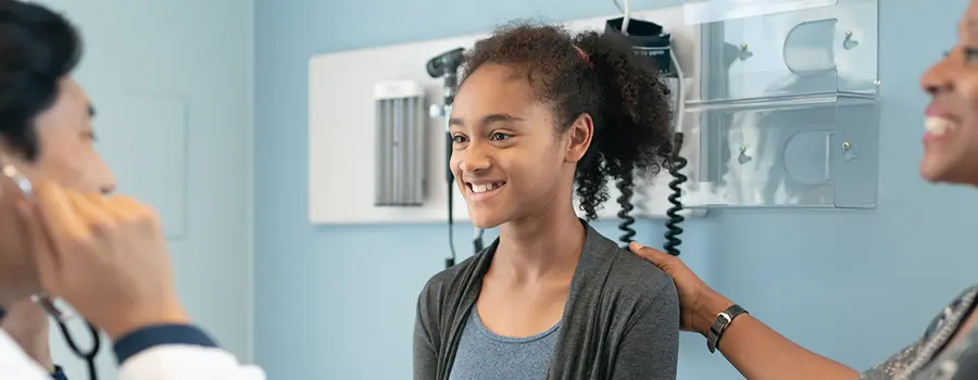 A child smiling at the doctor's office.