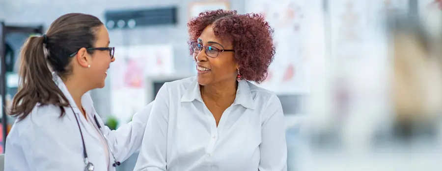 A doctor speaking with a smiling patient