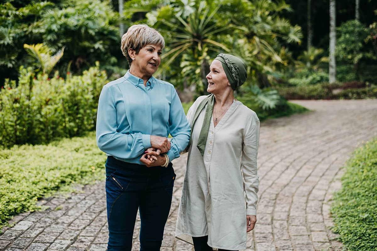 A woman walking with and comforting another woman