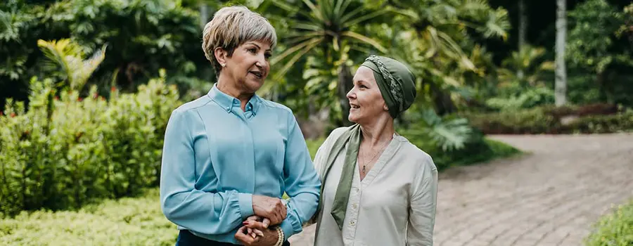 A woman walking with and comforting another woman