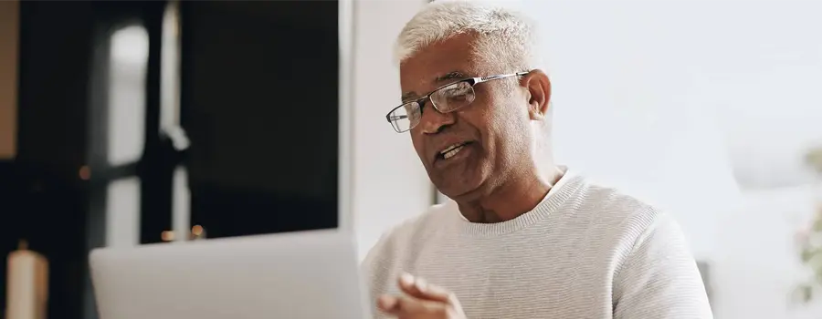 A man participating in a video conference from home